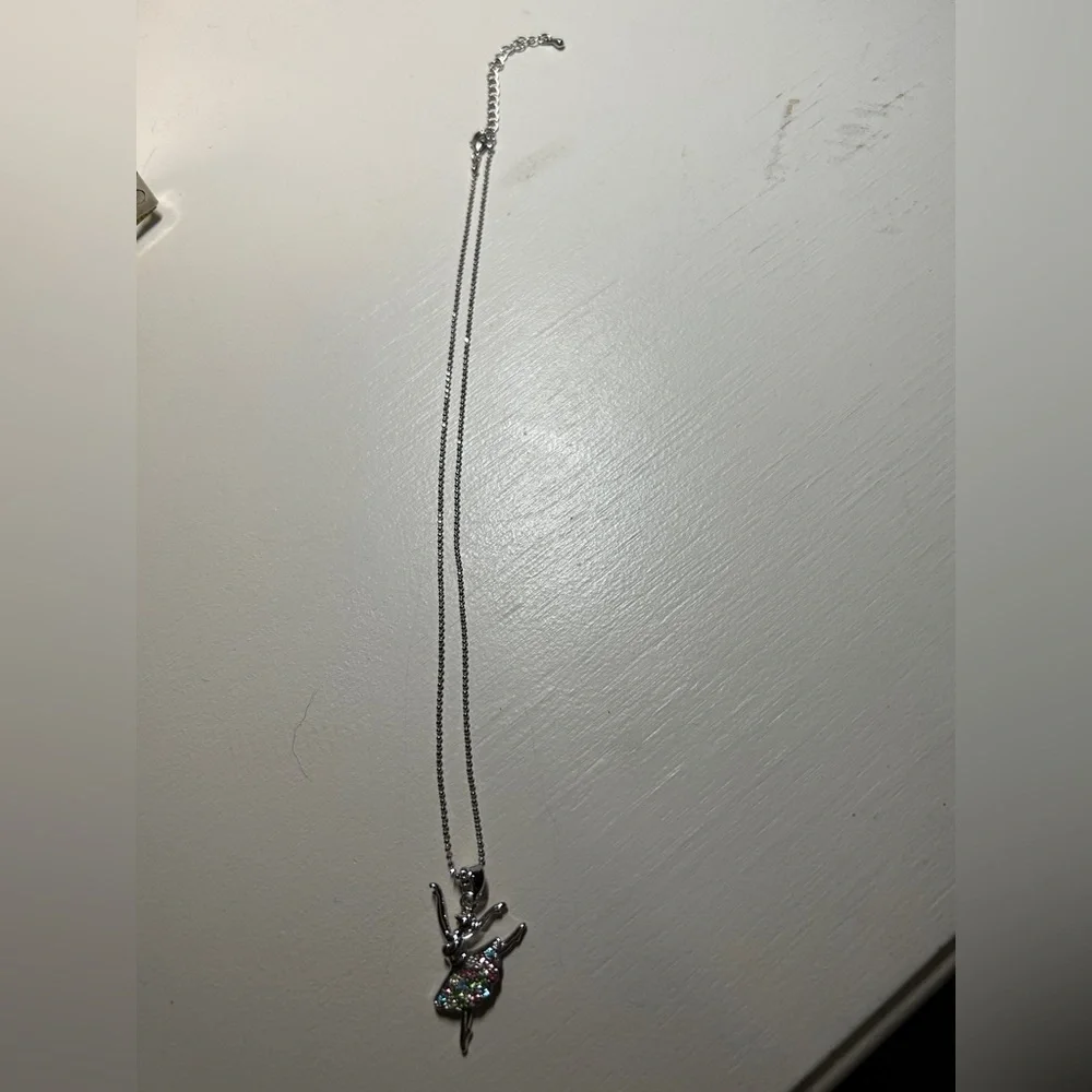 Girls 16” silver necklace with 2” extender. Has a ballerina pendant with stones.